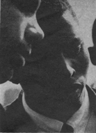 heads of two men conferring