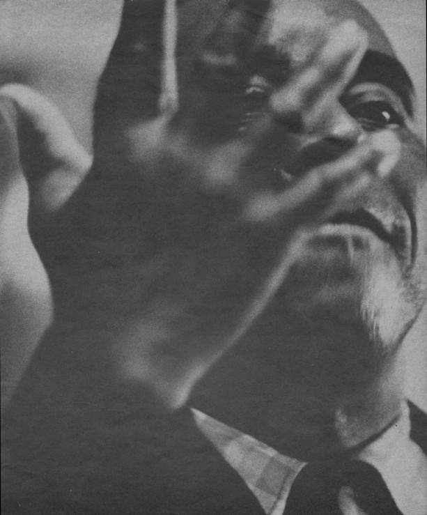 full-page man's face holding up back of hand