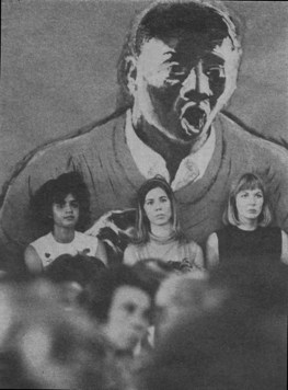 three pensive apparent female volunteers sitting against a wall mural of man singing, seen over heads of others